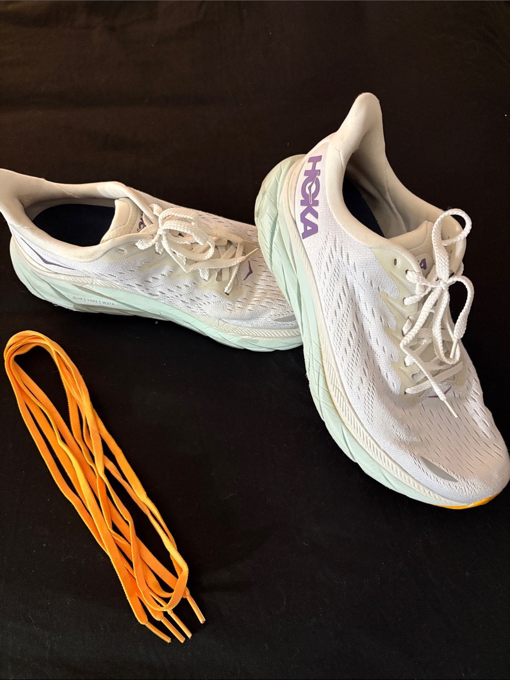 Hoka Women’s White Running Shoes with Light Green Soles and Purple Logo